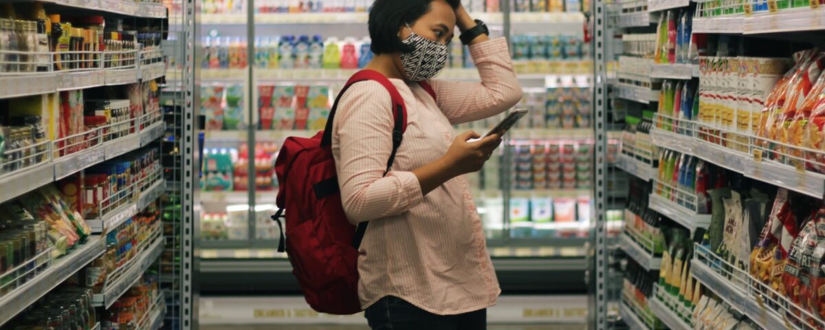 Mulher fazendo compras, tentando economizar no mercado