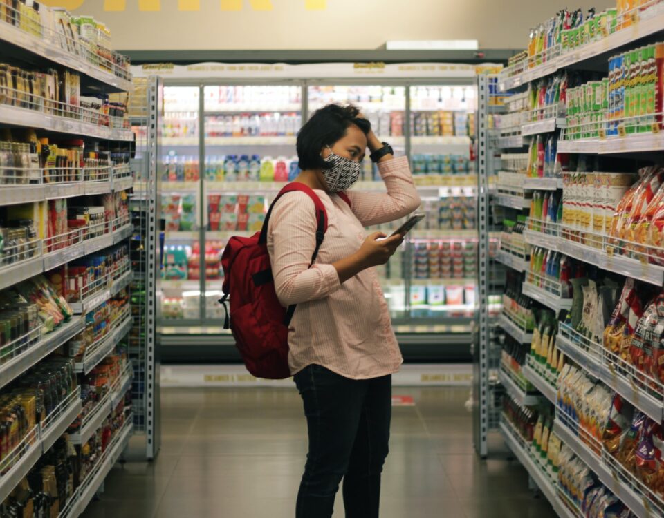 Mulher fazendo compras, tentando economizar no mercado